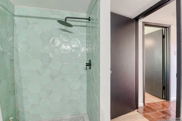 a bathroom with a glass shower door