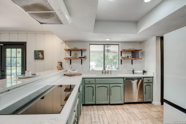a kitchen with a sink stove and cabinets