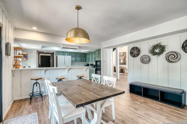 a dining room with furniture and window