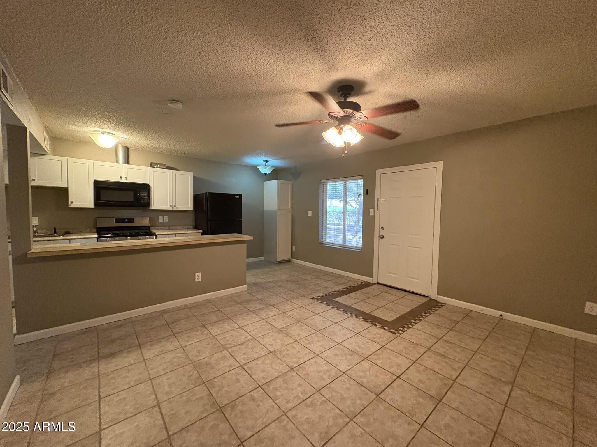 2735 West Tuckey Lane, Unit 2 Phoenix, AZ 85017 - Photo 2 of 8 a view of a kitchen with microwave and cabinets