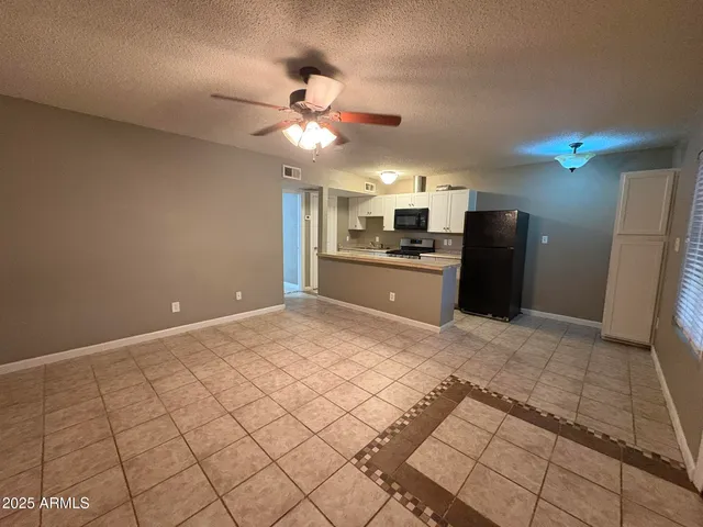 a view of a kitchen with a sink and a refrigerator