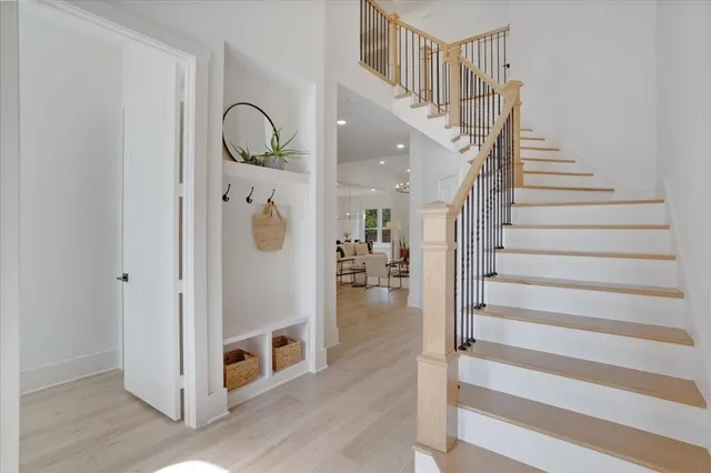 a view of entryway and hall with wooden floor