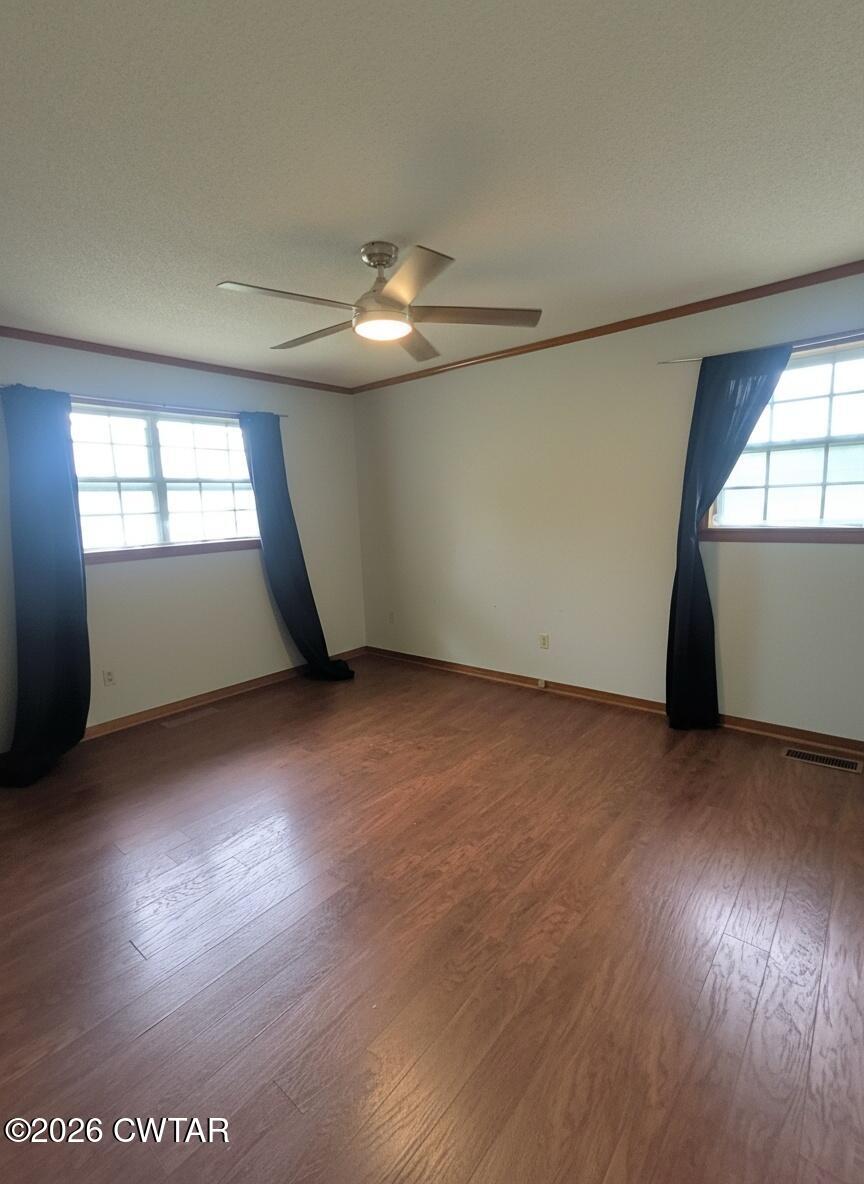 513 Viar Road Dyersburg, TN 38024 - Photo 21 of 37 an empty room with wooden floor and windows