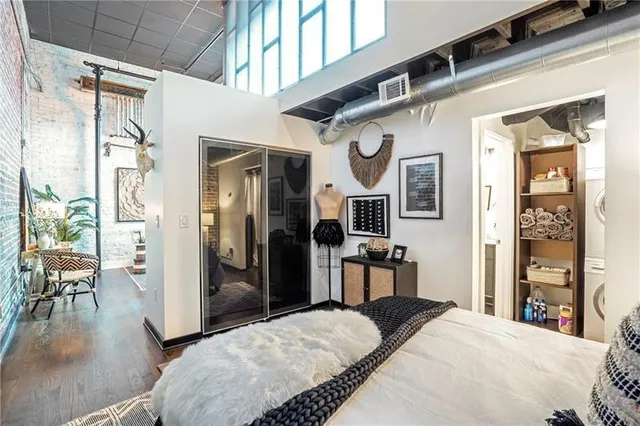 a bedroom with a bed closet and a large mirror