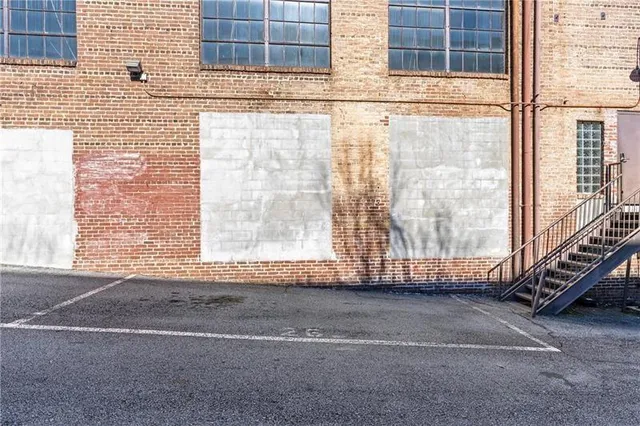 a view of a brick wall with an outdoor space