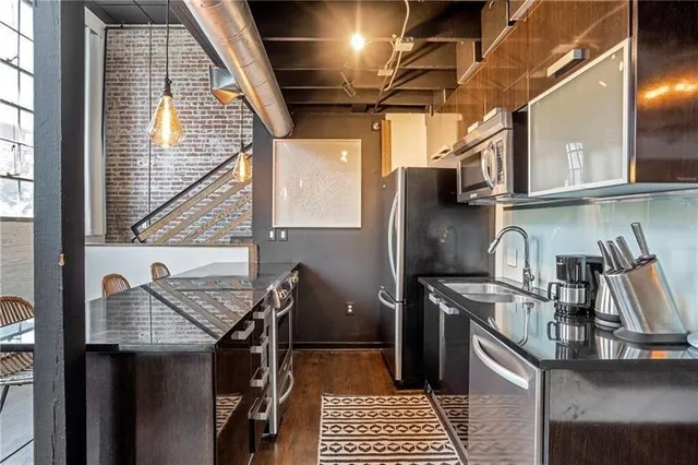 a kitchen that has a sink and a stove