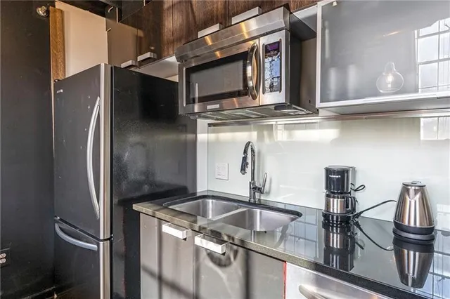 a kitchen with a refrigerator and a sink