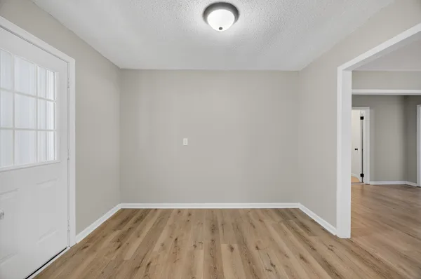 a view of a room with wooden floor