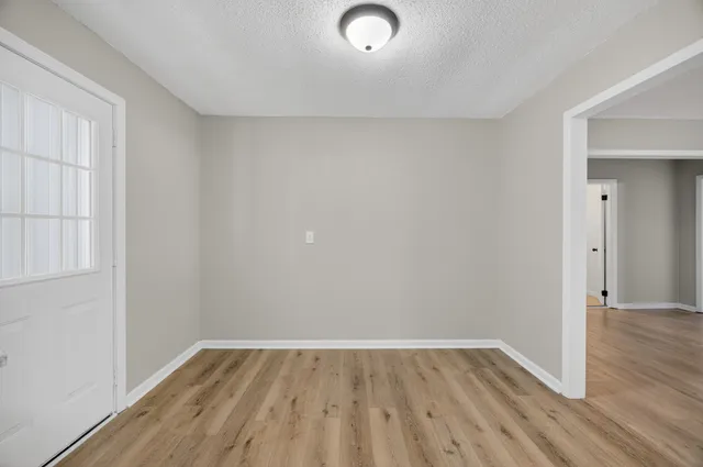 a view of a room with wooden floor