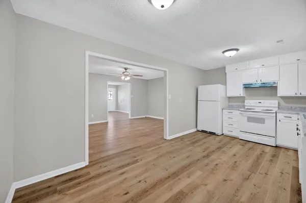 a view of a kitchen with wooden floor