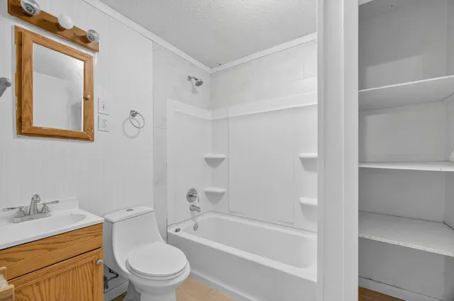 a bathroom with a toilet a sink and bathtub