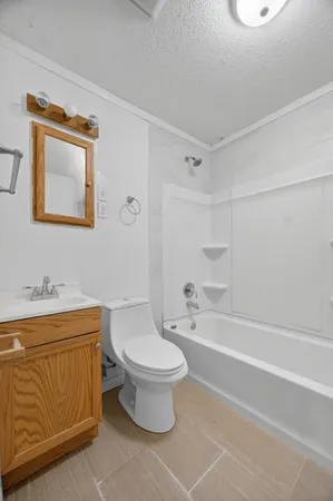 a bathroom with a toilet a sink and bathtub