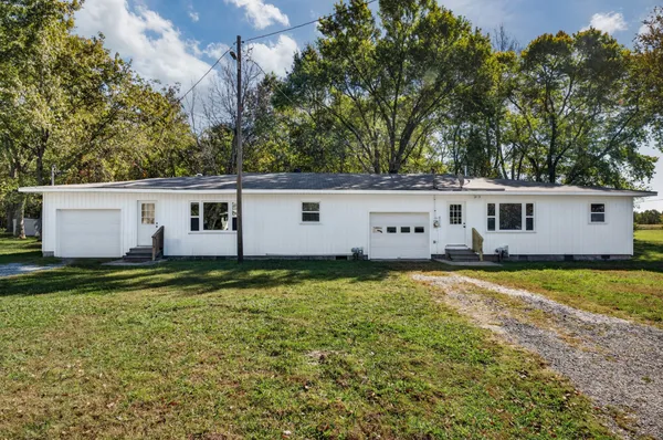 a view of a house with a backyard