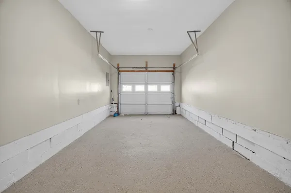 an empty room with windows and chandelier