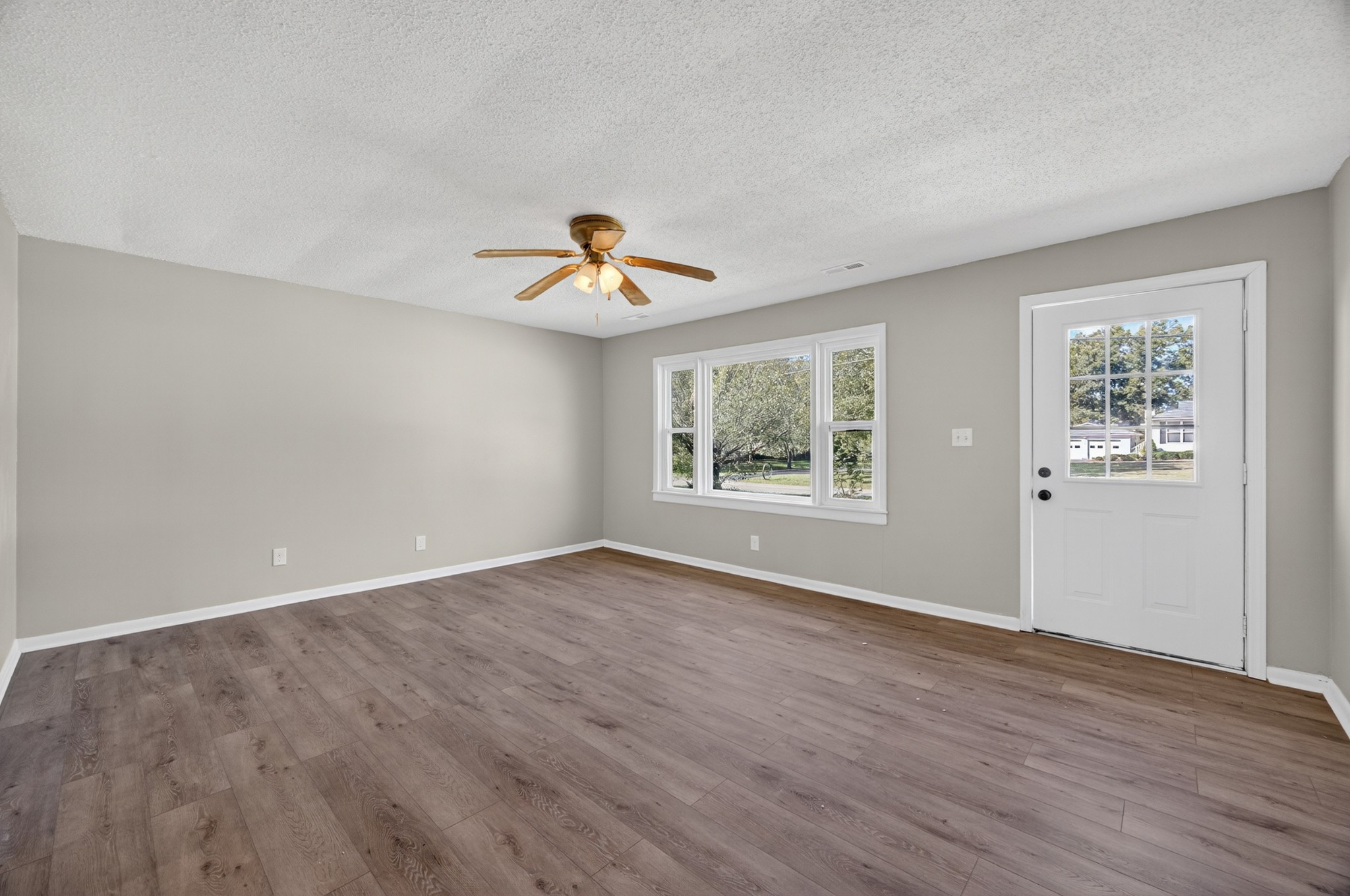 34 South Lincoln Road Fayetteville, TN 37334 - Photo 4 of 31 a view of an empty room with a window and wooden floor