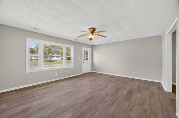 wooden floor in an empty room with a window
