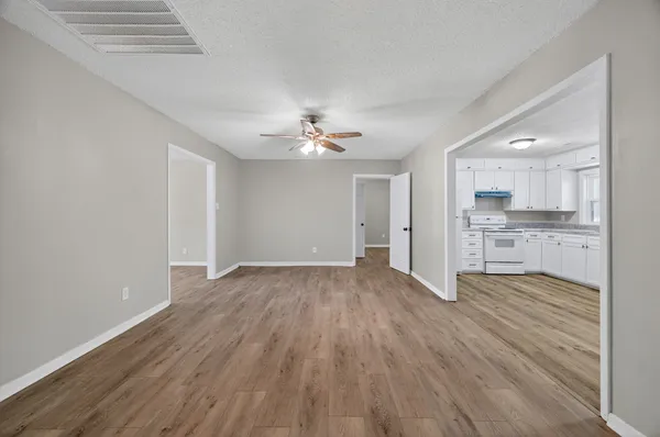 a view of a kitchen with wooden floor and a kitchen
