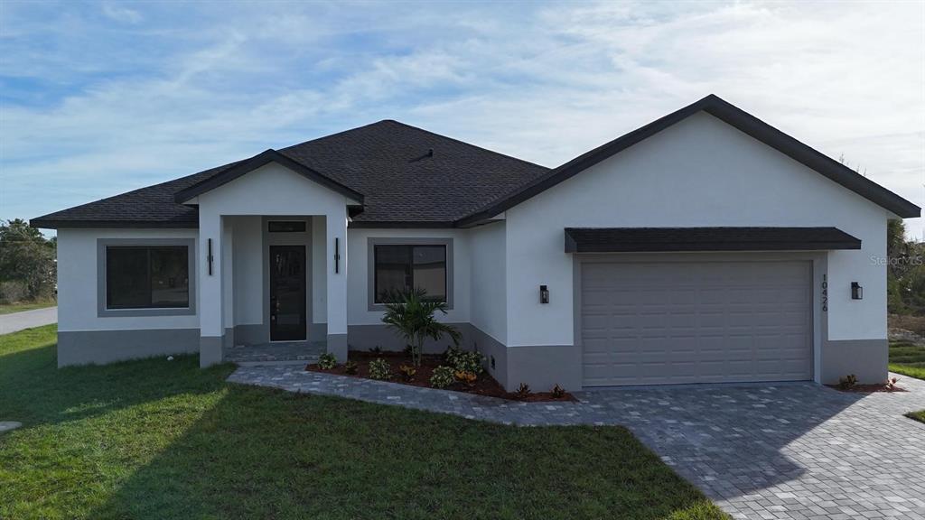 10426 Live Oak Road Port Charlotte, FL 33981 - Photo 15 of 53 a front view of house with a garden
