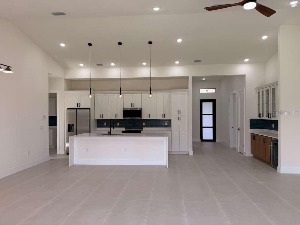 10426 Live Oak Road Port Charlotte, FL 33981 - Photo 16 of 53 a large kitchen with stainless steel appliances kitchen island a large counter top and oven