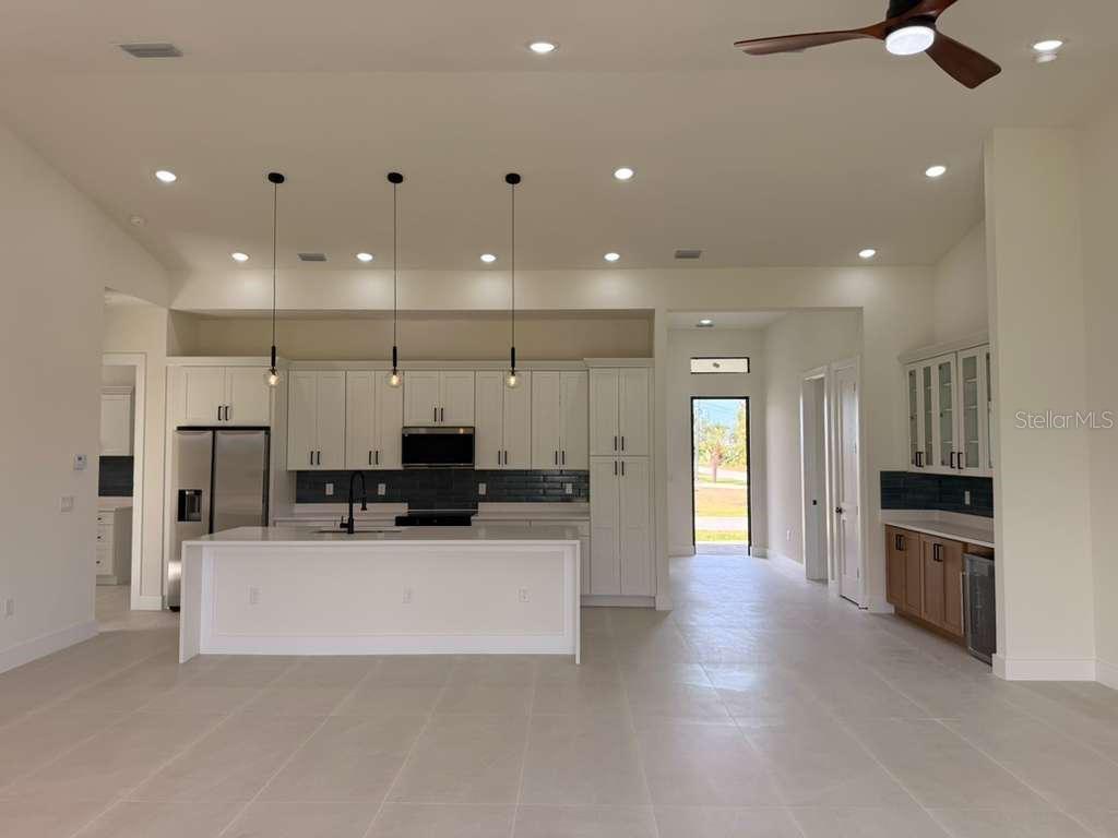 10426 Live Oak Road Port Charlotte, FL 33981 - Photo 17 of 53 a view of a kitchen with kitchen island a counter top space a sink stainless steel appliances and cabinets