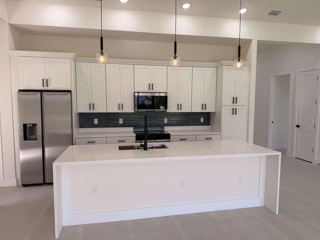 10426 Live Oak Road Port Charlotte, FL 33981 - Photo 19 of 53 a view of kitchen with stainless steel appliances granite countertop a sink a stove and a refrigerator