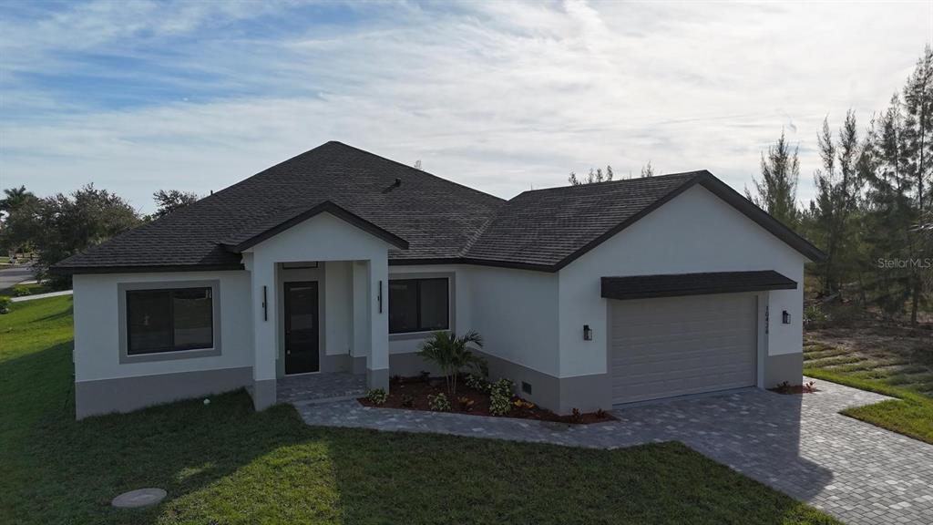 10426 Live Oak Road Port Charlotte, FL 33981 - Photo 2 of 53 a view of house with backyard and entertaining space