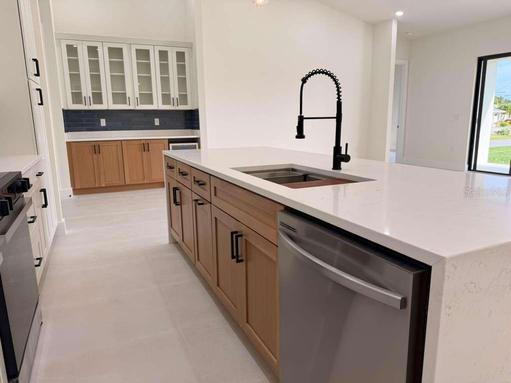 10426 Live Oak Road Port Charlotte, FL 33981 - Photo 25 of 53 a kitchen with stainless steel appliances granite countertop a sink a stove and a refrigerator