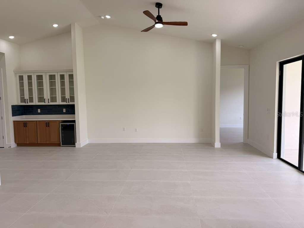 10426 Live Oak Road Port Charlotte, FL 33981 - Photo 28 of 53 an empty room with kitchen view and a window