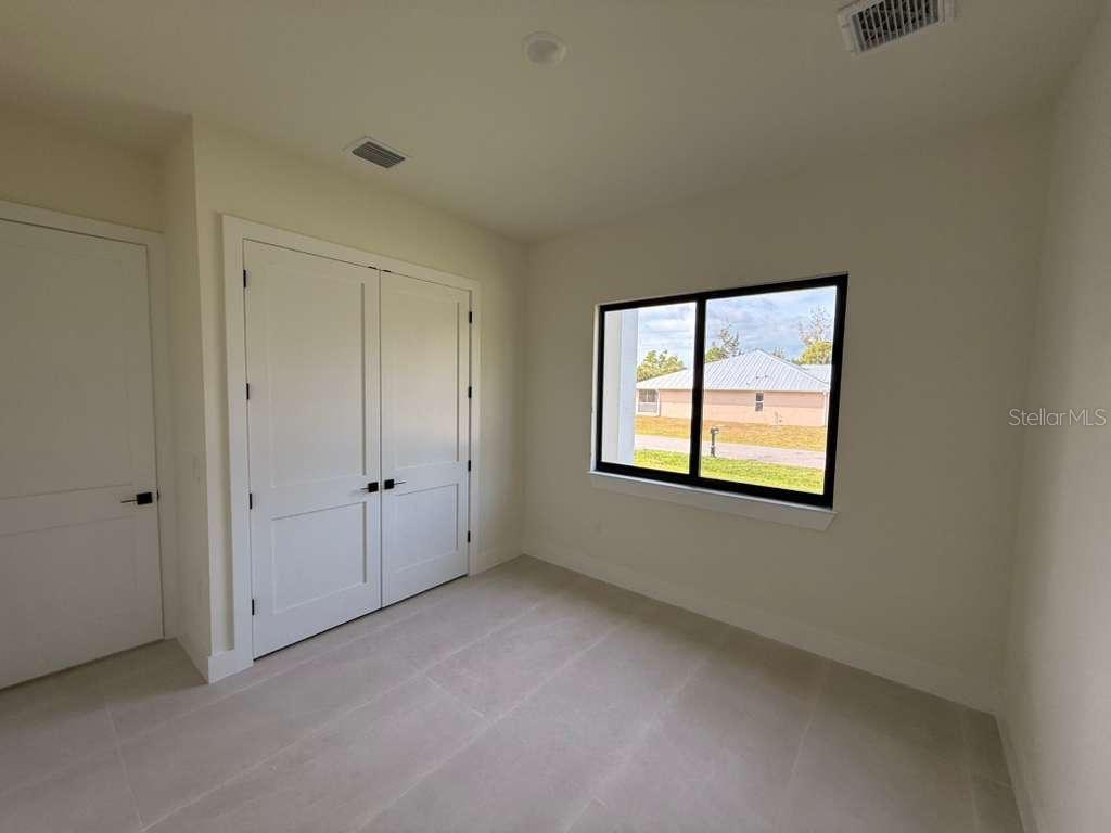 10426 Live Oak Road Port Charlotte, FL 33981 - Photo 32 of 53 a view of an empty room with a window