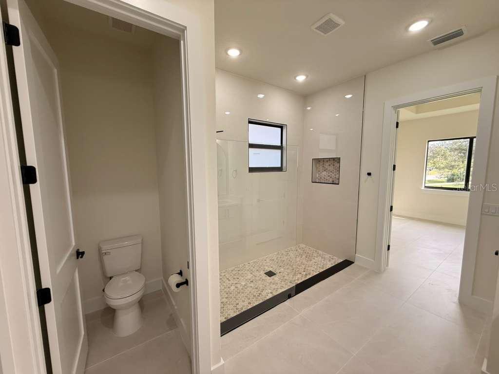 10426 Live Oak Road Port Charlotte, FL 33981 - Photo 35 of 53 a bathroom with a granite countertop sink a toilet and shower