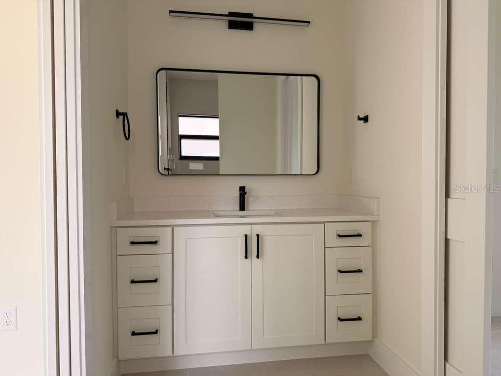 10426 Live Oak Road Port Charlotte, FL 33981 - Photo 38 of 53 a bathroom with a sink and a mirror