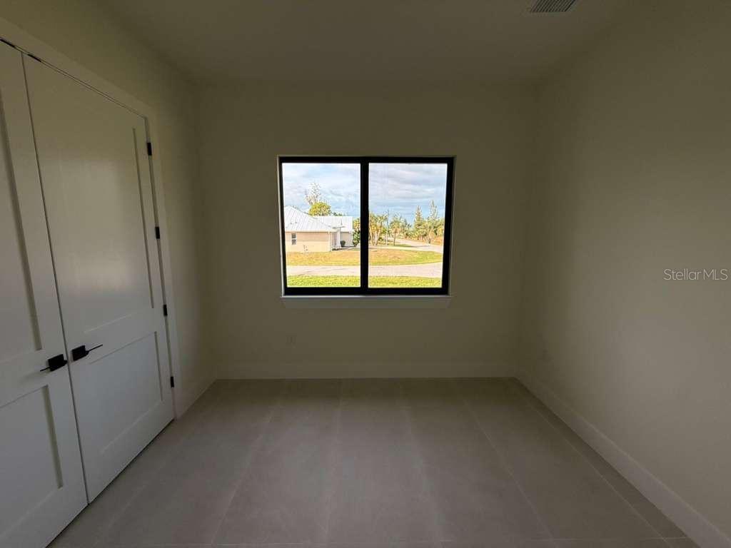 10426 Live Oak Road Port Charlotte, FL 33981 - Photo 39 of 53 an empty room with a window