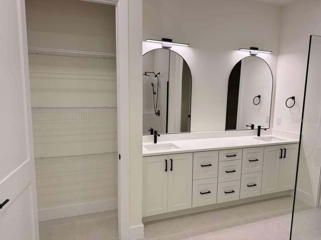 10426 Live Oak Road Port Charlotte, FL 33981 - Photo 40 of 53 a bathroom with a double vanity sink and a mirror