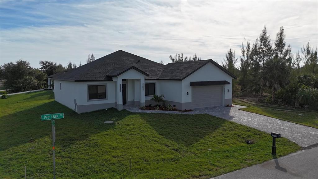 10426 Live Oak Road Port Charlotte, FL 33981 - Photo 4 of 53 a front view of a house with garden