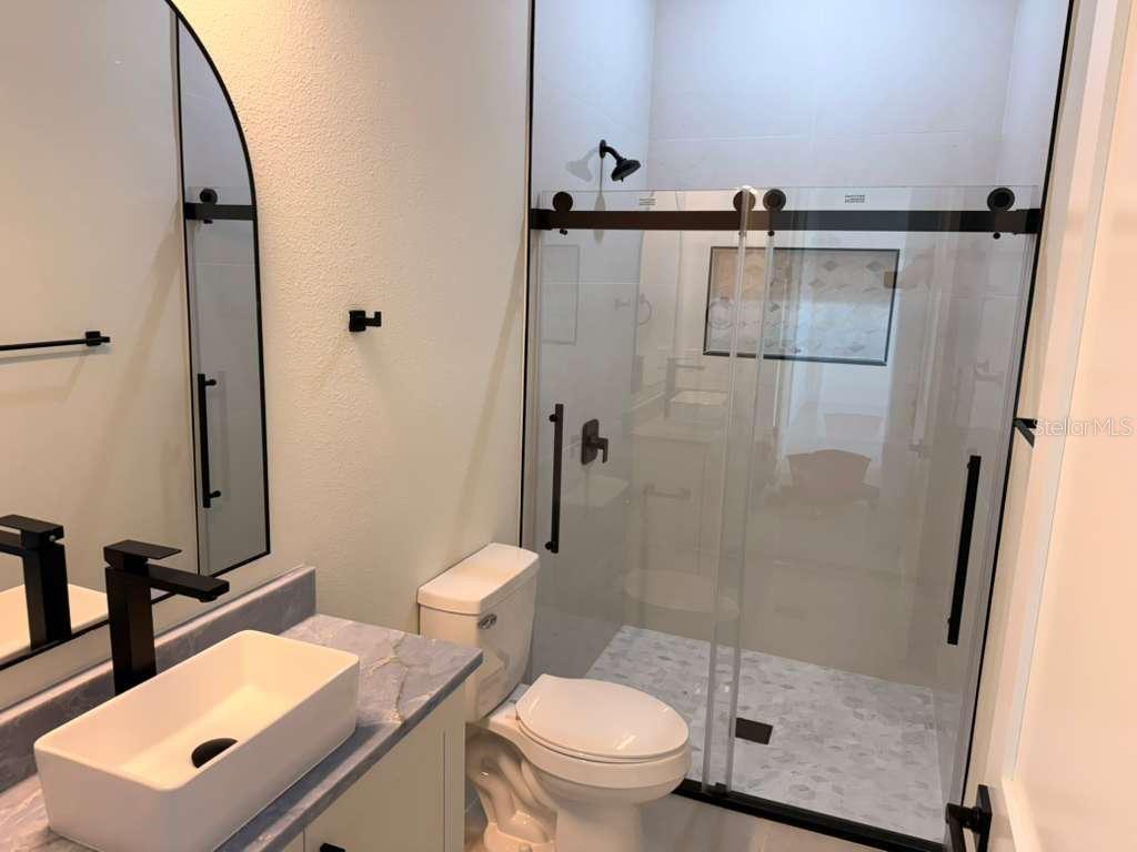 10426 Live Oak Road Port Charlotte, FL 33981 - Photo 42 of 53 a bathroom with a toilet and a shower