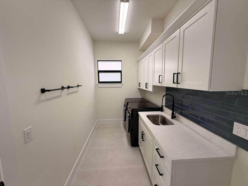 10426 Live Oak Road Port Charlotte, FL 33981 - Photo 45 of 53 a kitchen that has a sink and a stove in it