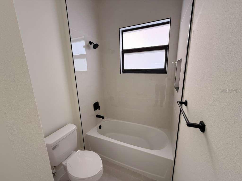10426 Live Oak Road Port Charlotte, FL 33981 - Photo 48 of 53 a white bath tub sitting next to a white toilet