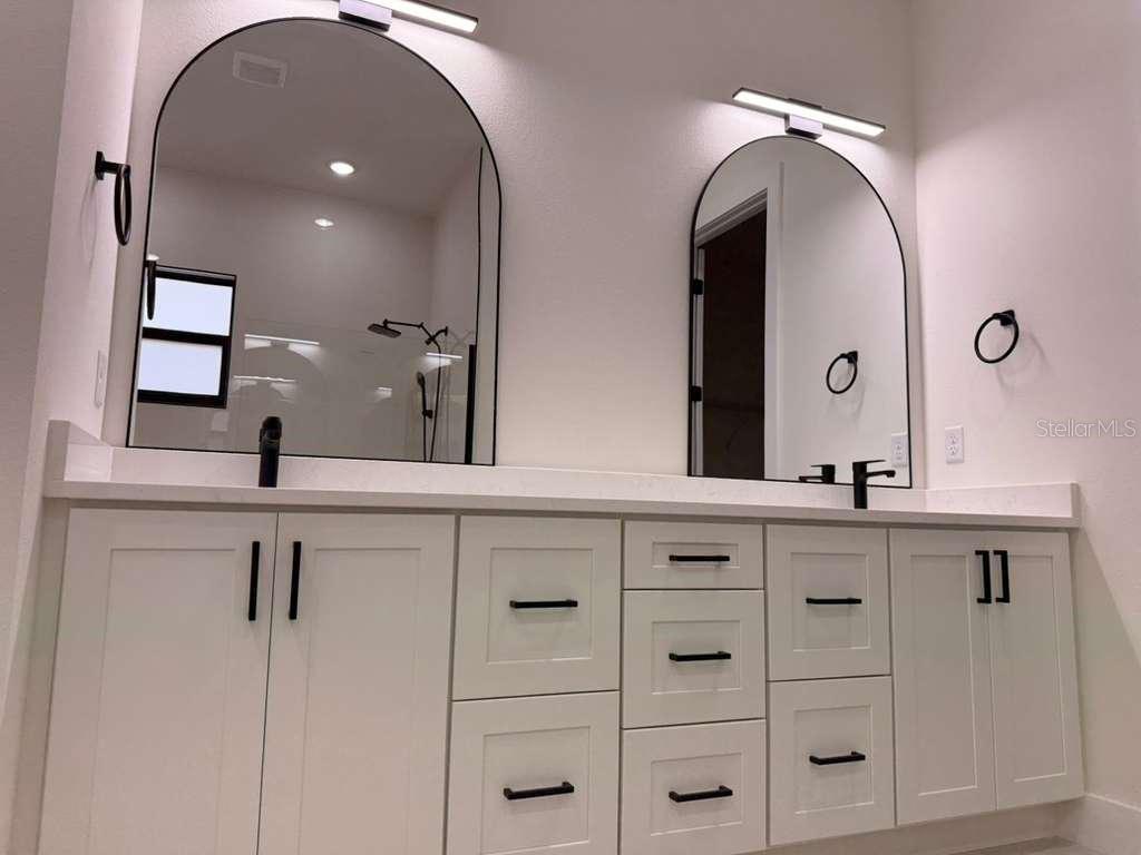10426 Live Oak Road Port Charlotte, FL 33981 - Photo 50 of 53 a bathroom with double sink and a mirror