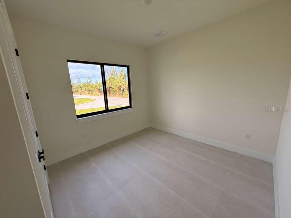 10426 Live Oak Road Port Charlotte, FL 33981 - Photo 51 of 53 an empty room with windows