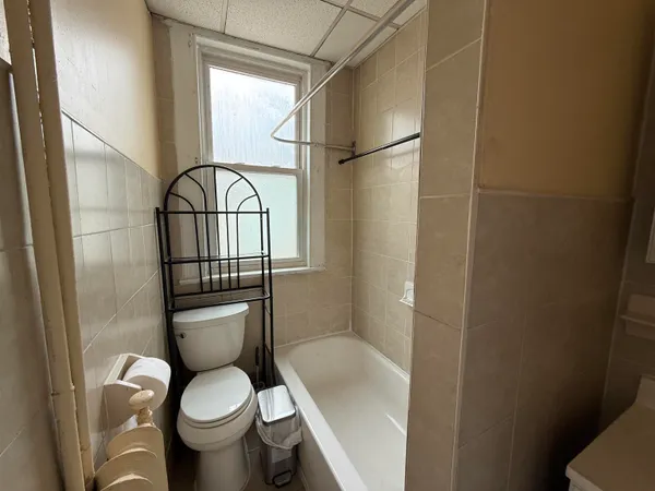 a white toilet sitting next to a bathroom sink