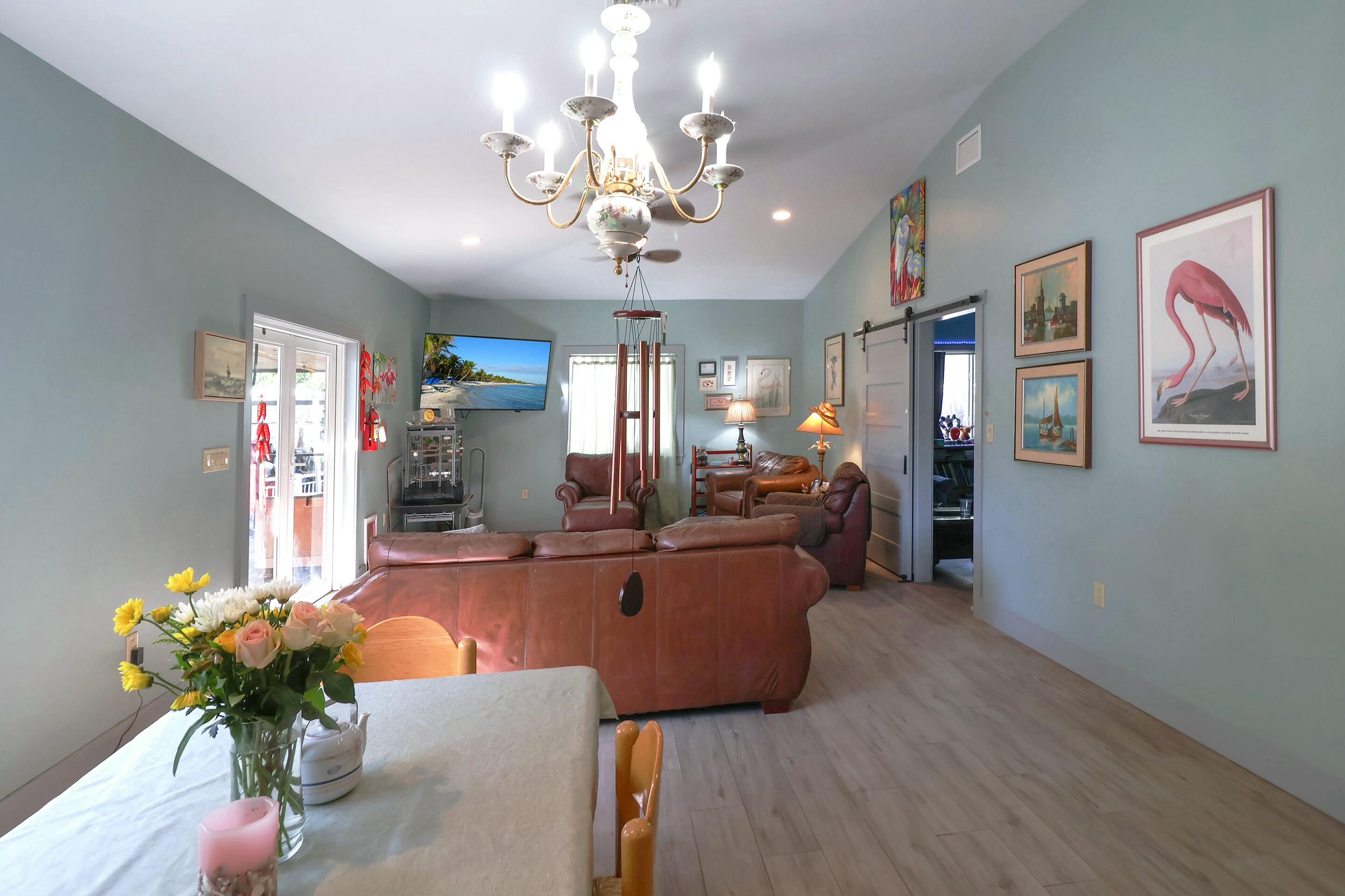 129 Lazy Lane Key Largo, FL 33037 - Photo 35 of 35 a living room with furniture wooden floor and chandelier