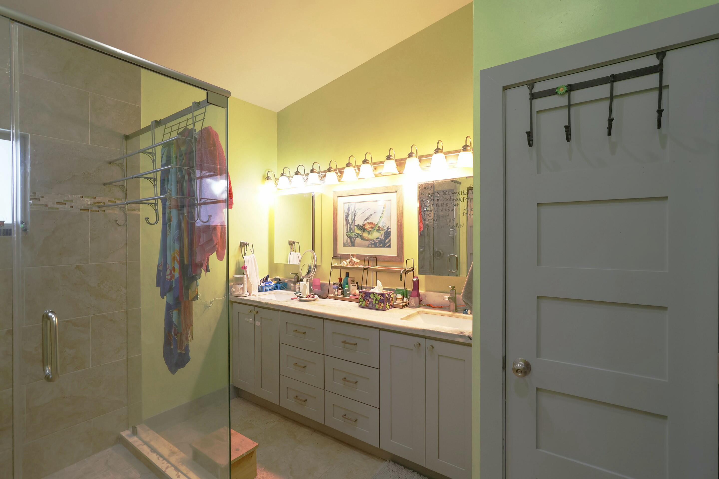 129 Lazy Lane Key Largo, FL 33037 - Photo 12 of 35 a bathroom with a double vanity sink mirror and shower