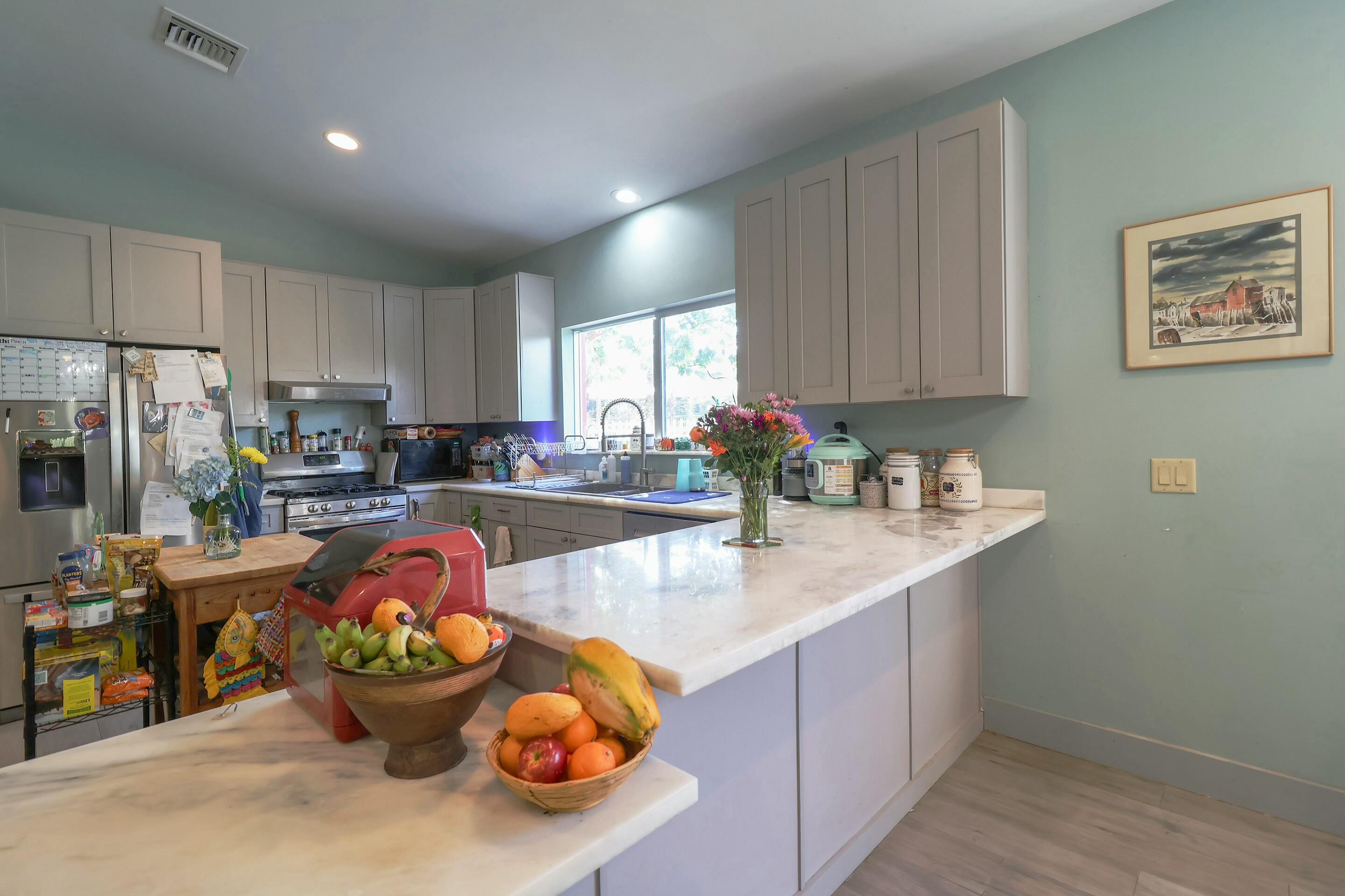 129 Lazy Lane Key Largo, FL 33037 - Photo 3 of 35 a kitchen with stainless steel appliances granite countertop a sink stove and refrigerator