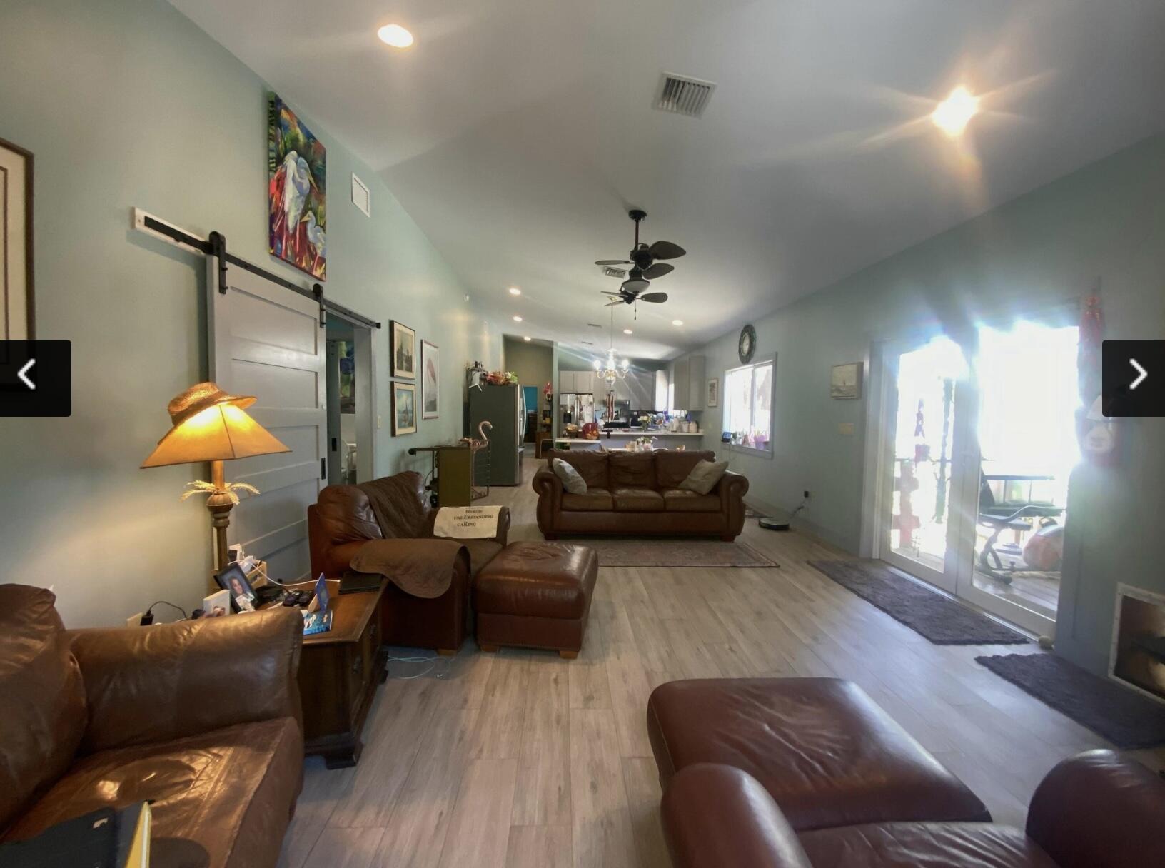 129 Lazy Lane Key Largo, FL 33037 - Photo 6 of 35 a living room with furniture a ceiling fan and a rug