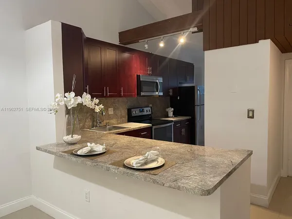 a kitchen with sink and refrigerator