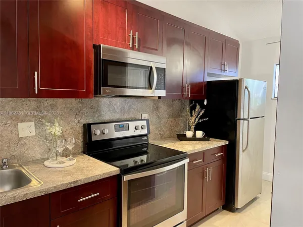 a kitchen with a stove microwave and refrigerator