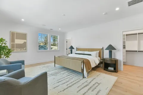 a spacious bedroom with a bed and a couch