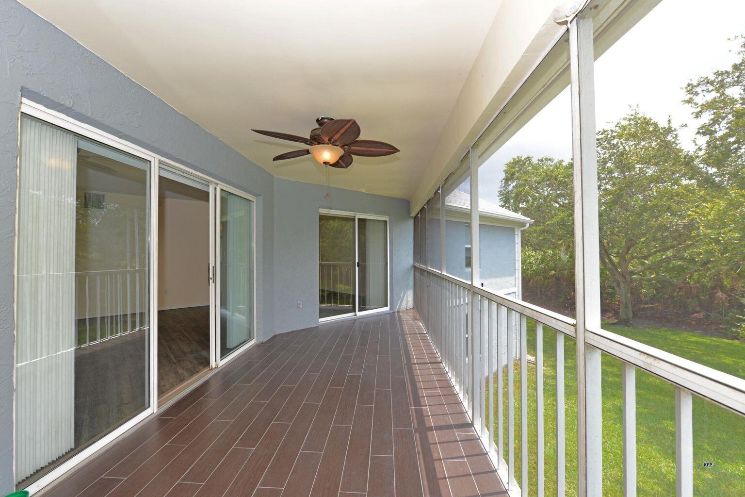 3254 Southeast Aster Lane, Unit 239 Stuart, FL 34994 - Photo 13 of 24 a view of a balcony with wooden floor