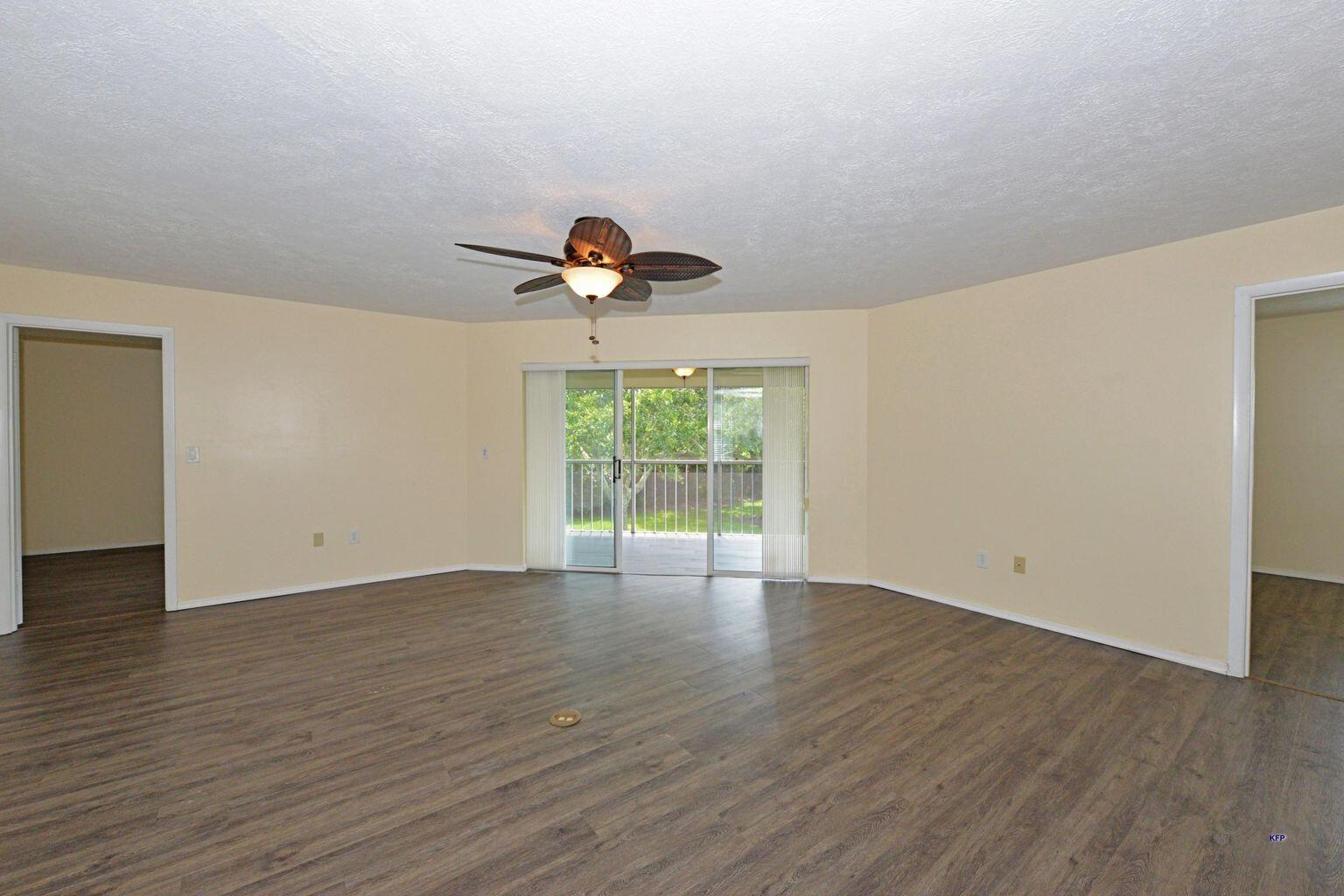 3254 Southeast Aster Lane, Unit 239 Stuart, FL 34994 - Photo 14 of 24 a view of an empty room with wooden floor and a window