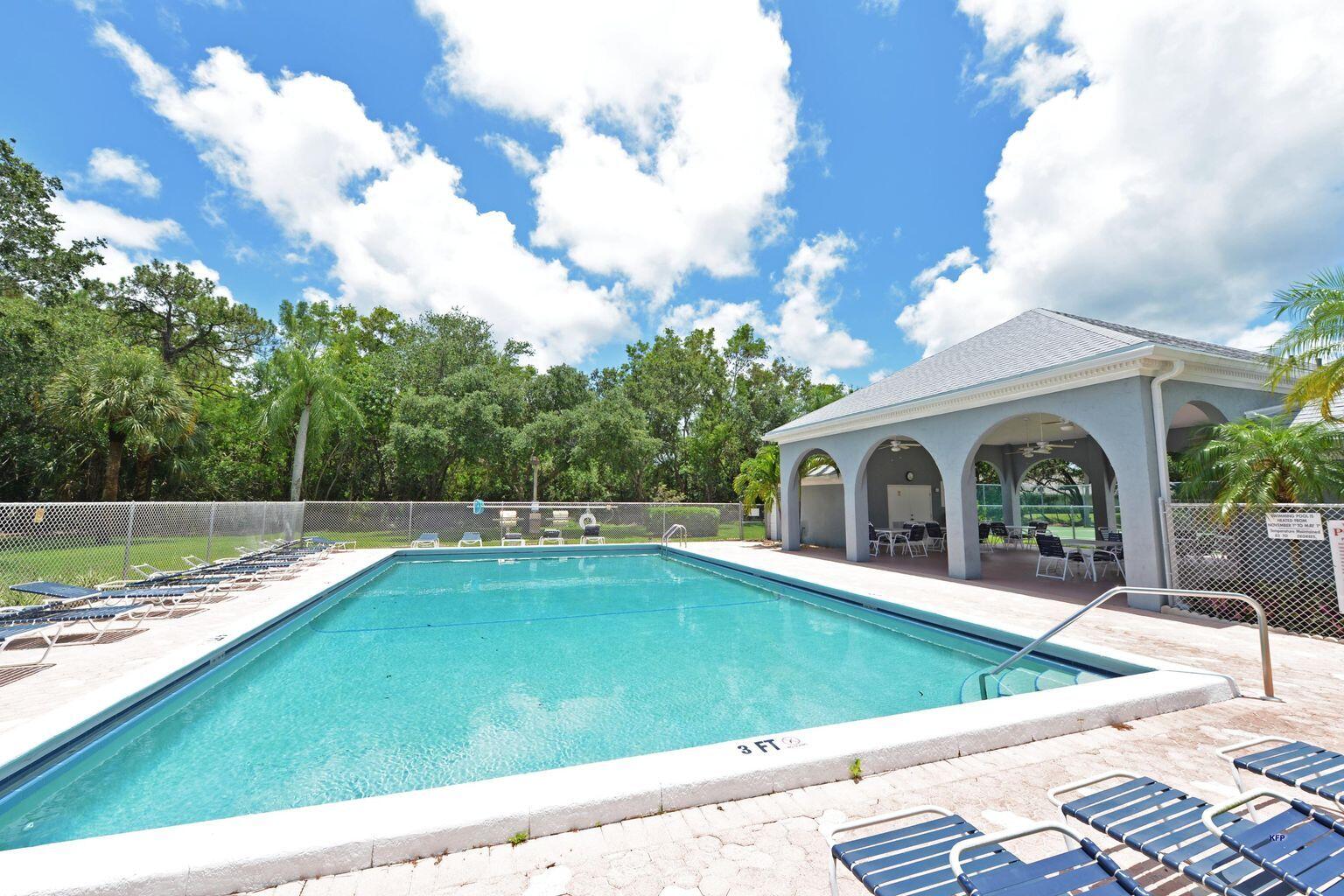 3254 Southeast Aster Lane, Unit 239 Stuart, FL 34994 - Photo 2 of 24 a view of a house with swimming pool and a yard